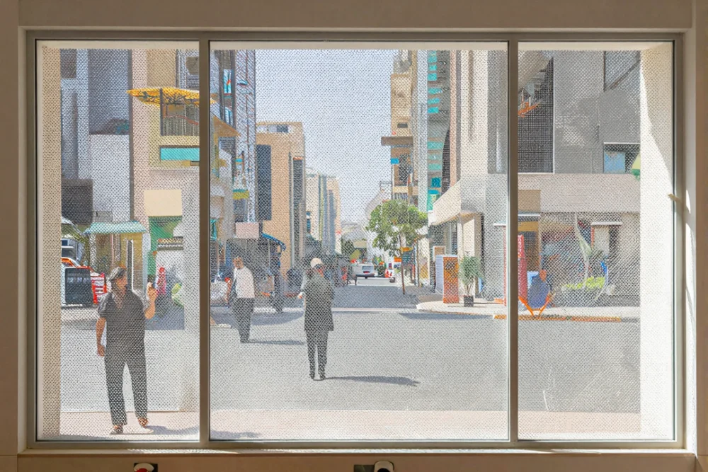 Window Graphics Dubai: Transform Your Retail Space 1 Interior view of a shop showing how perforated vinyl allows natural light and outside visibility.